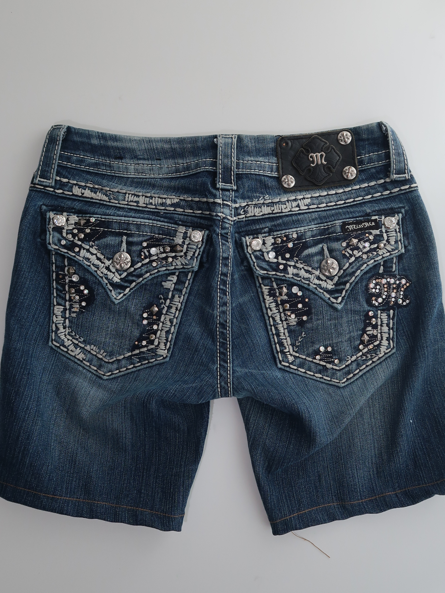 A007: “y2k diva” | denim ‘miss me’ shorts with embellished pockets MISSING BUTTON