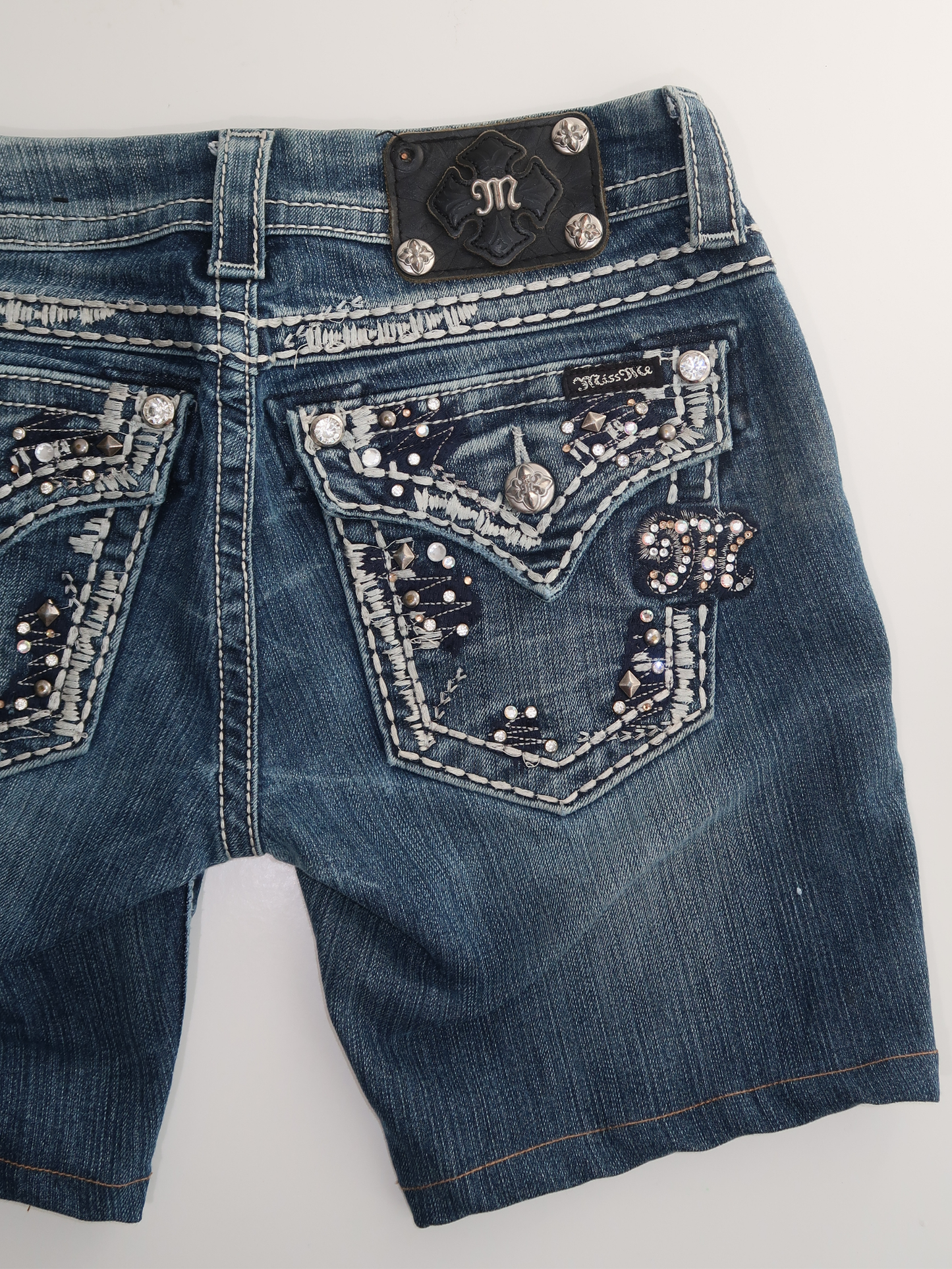 A007: “y2k diva” | denim ‘miss me’ shorts with embellished pockets MISSING BUTTON