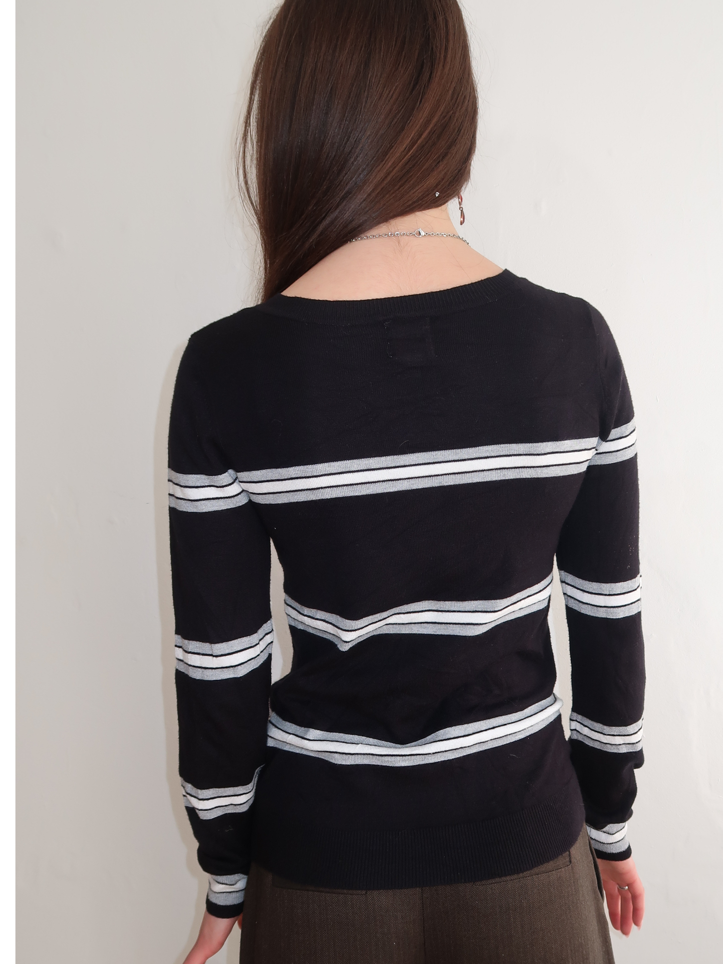 A052: “the intern” | v neck black, white and grey striped jumper.