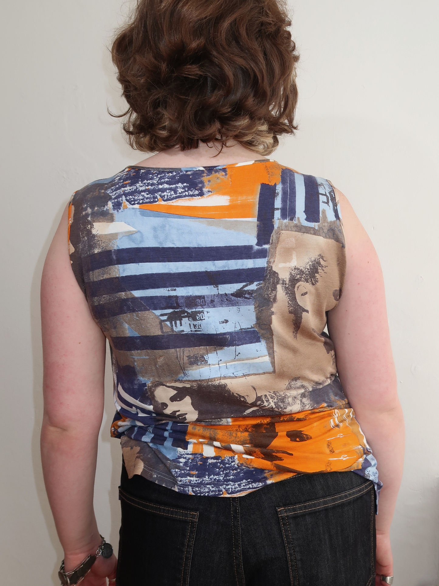 A046: “faces everywhere” | bold 90s vest top
